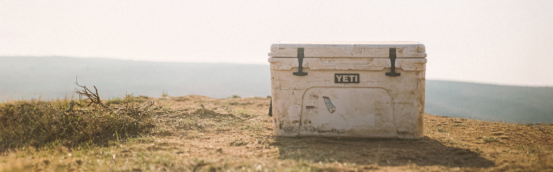 White YETI cooler at the top of a hill.