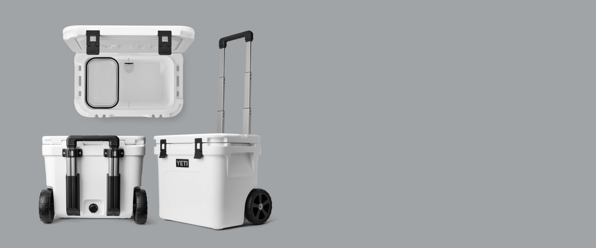 Two white coolers with wheels on a gray background