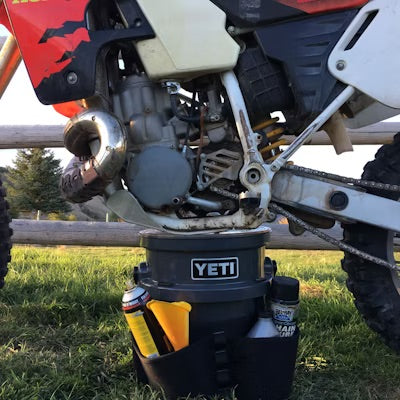 Person holding a YETI branded mug with coffee