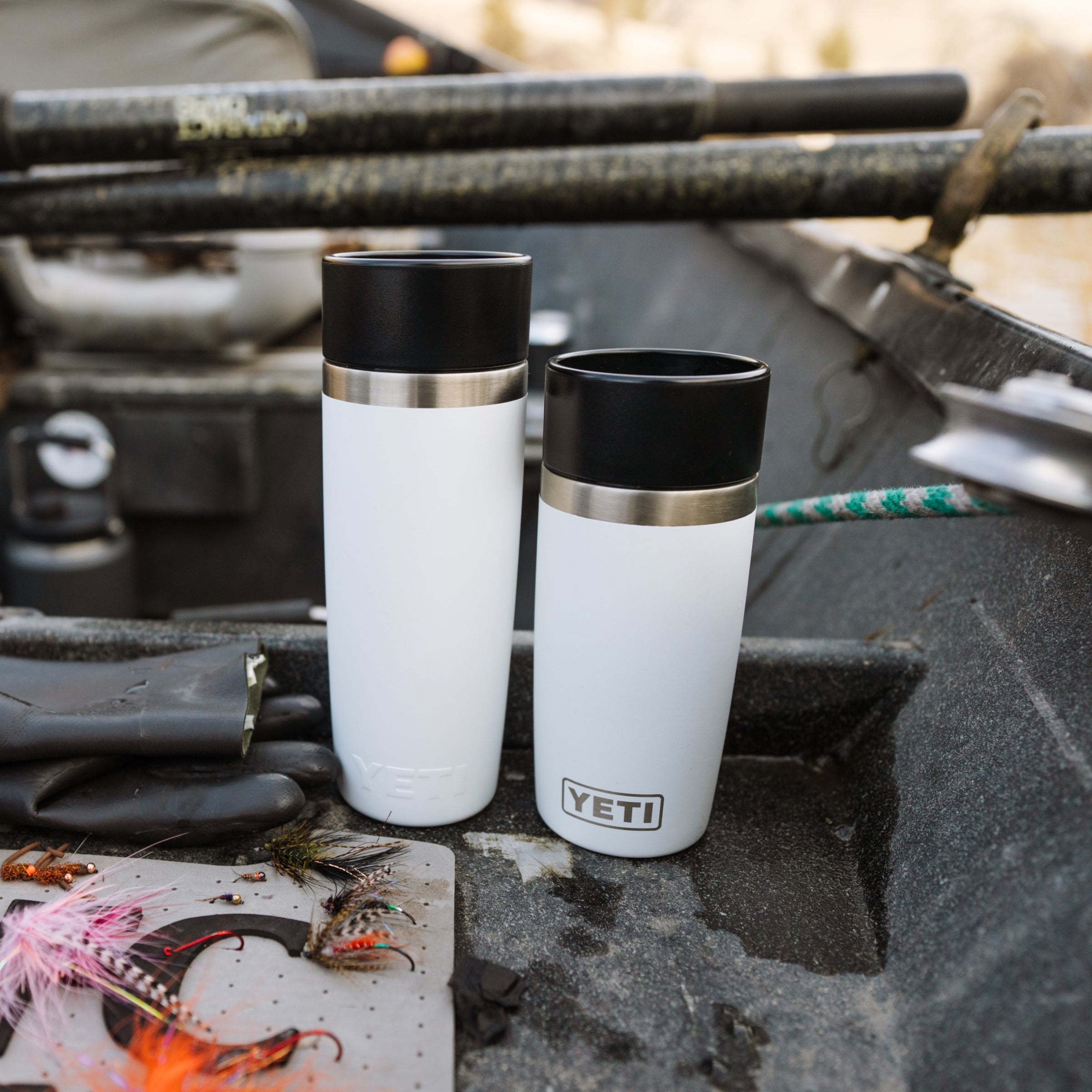 Person holding a YETI branded mug with coffee