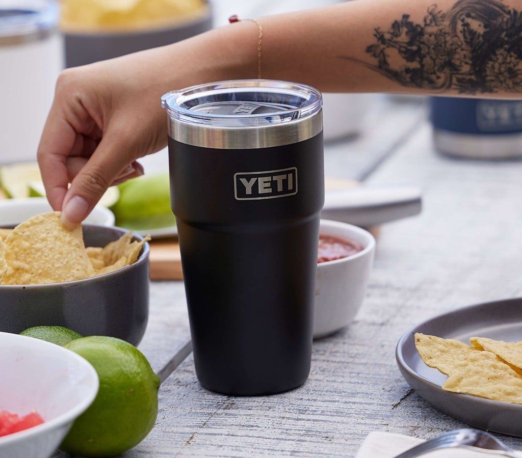Blue mugs with 'YETI' logo in a dishwasher rack.