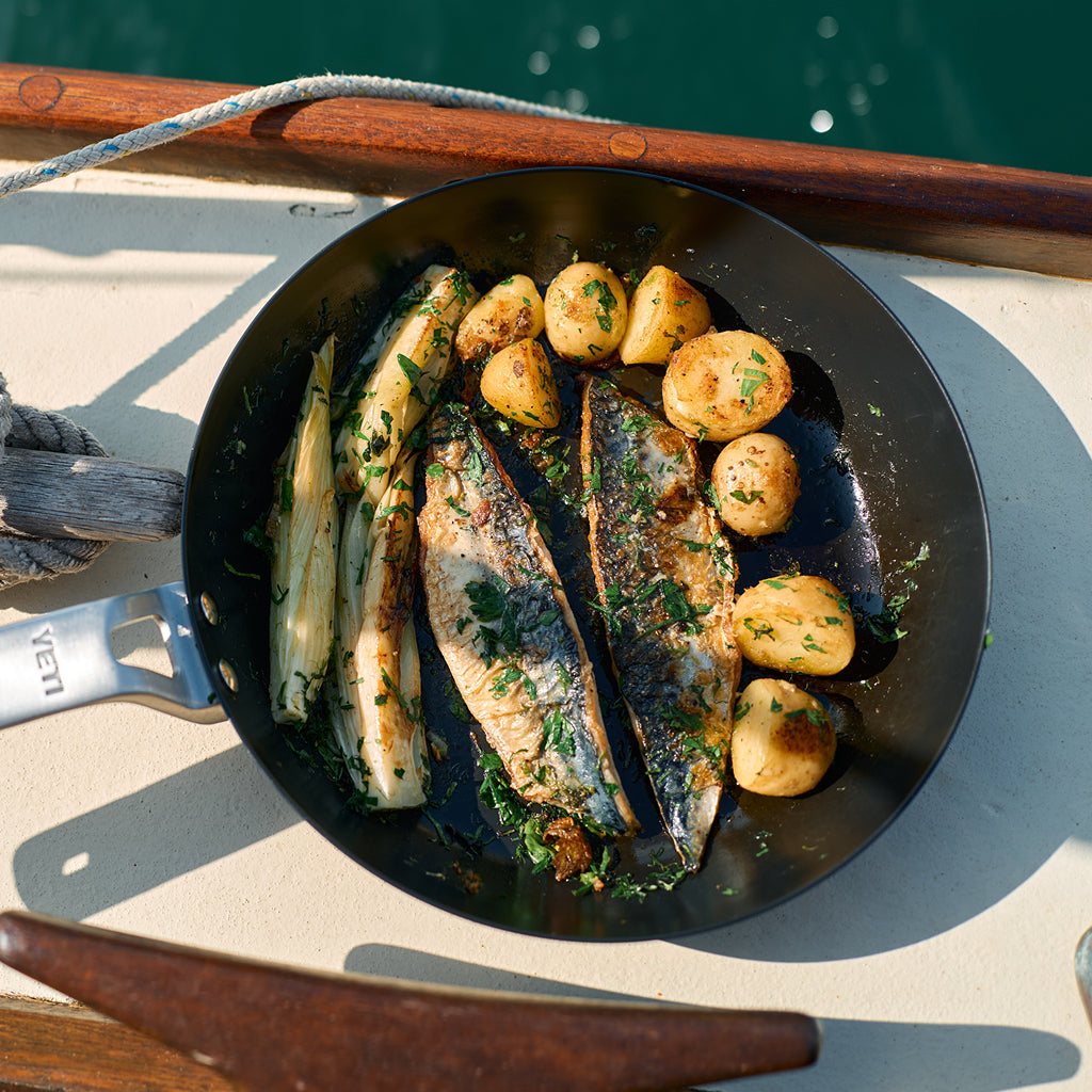 YETI frying pan with fish and vegetables on a boat