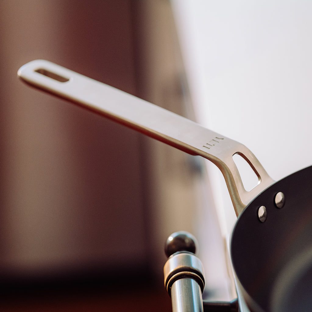 Close-up of a YETI frying pan handle with a blurred background