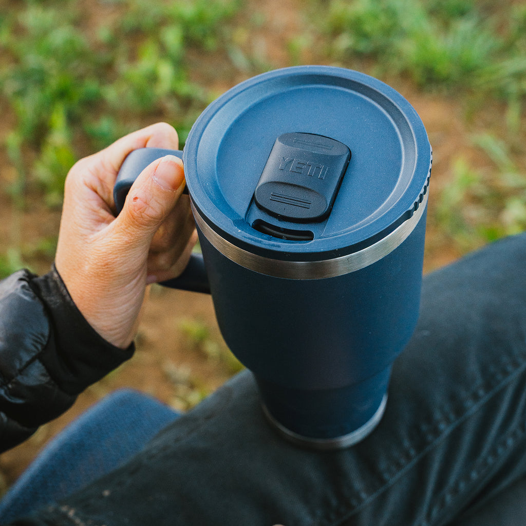 Person holding a YETI Rambler Travel Mug with leakproof lid