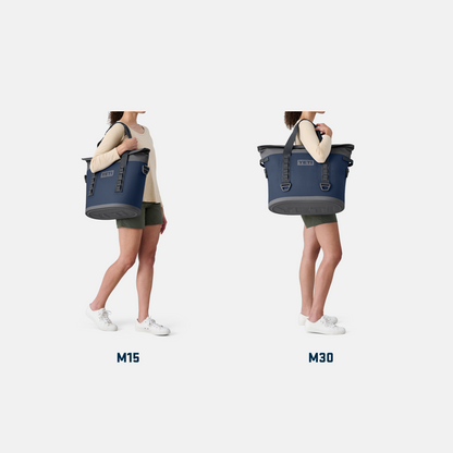 Two people holding blue tote bags labeled M15 and M30 on a white background