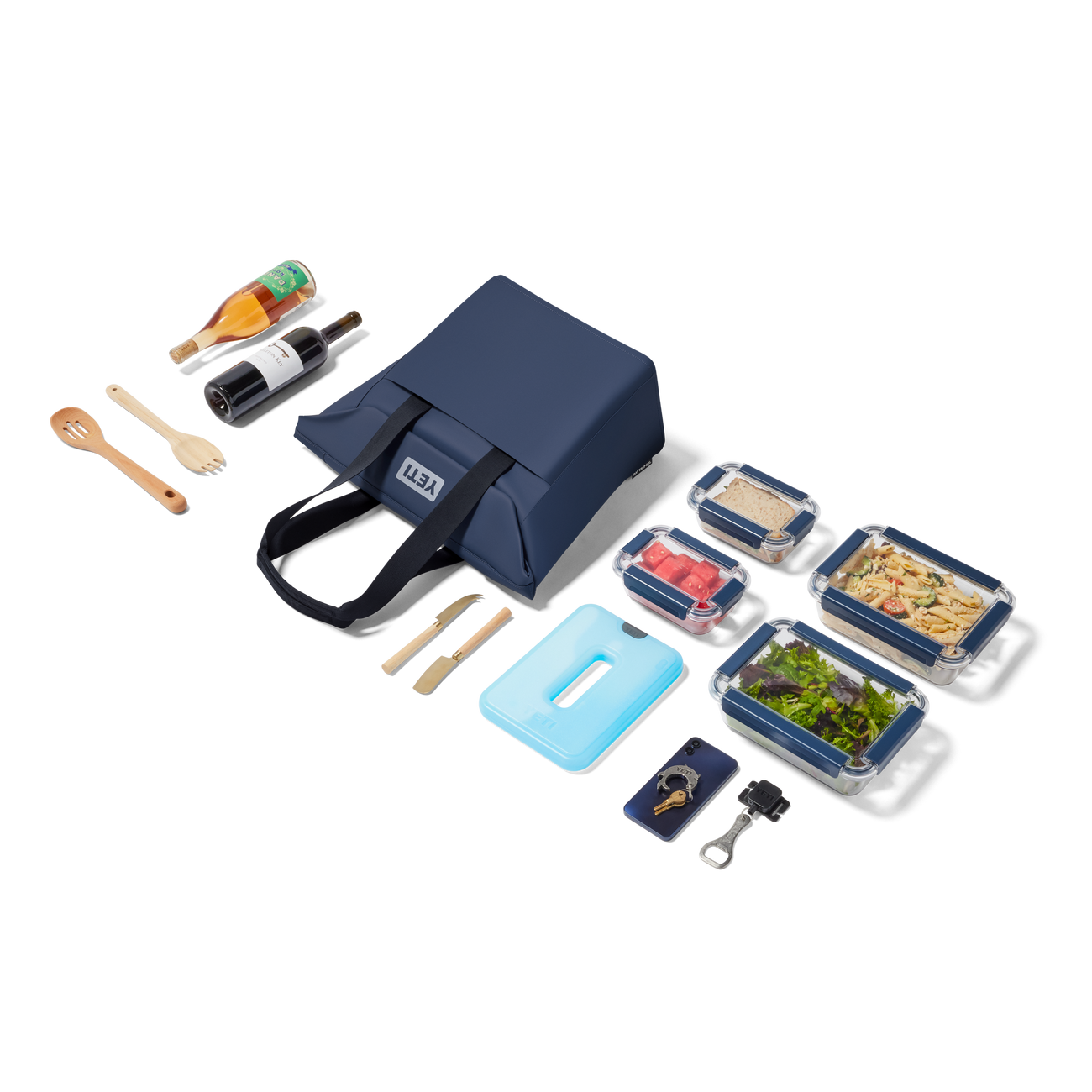 Navy YETI picnic tote with food containers, utensils, and condiments.