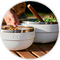 Two white bowls on a wooden surface with a blurred background