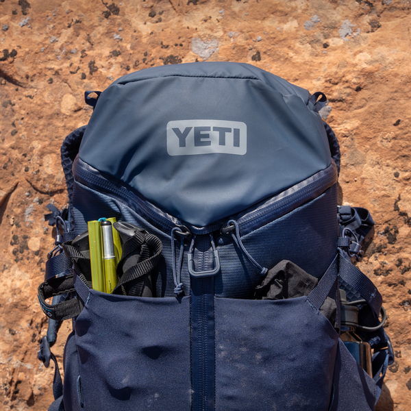 Blue YETI backpack on a rocky surface