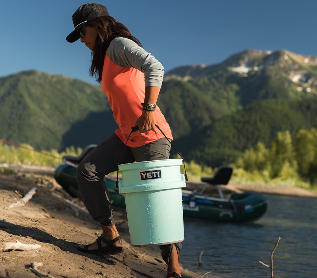 Person holding a YETI branded mug with coffee