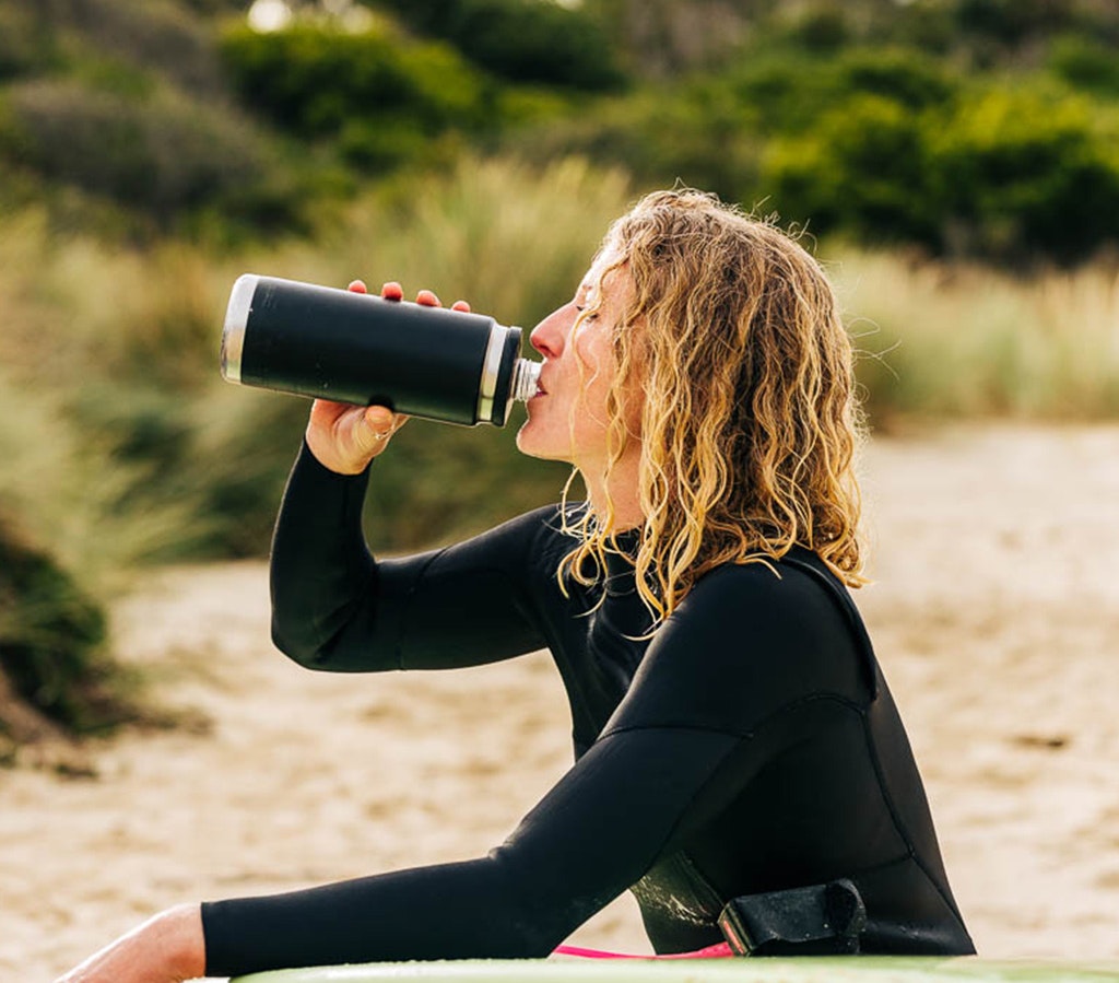 Person holding a YETI branded mug with coffee