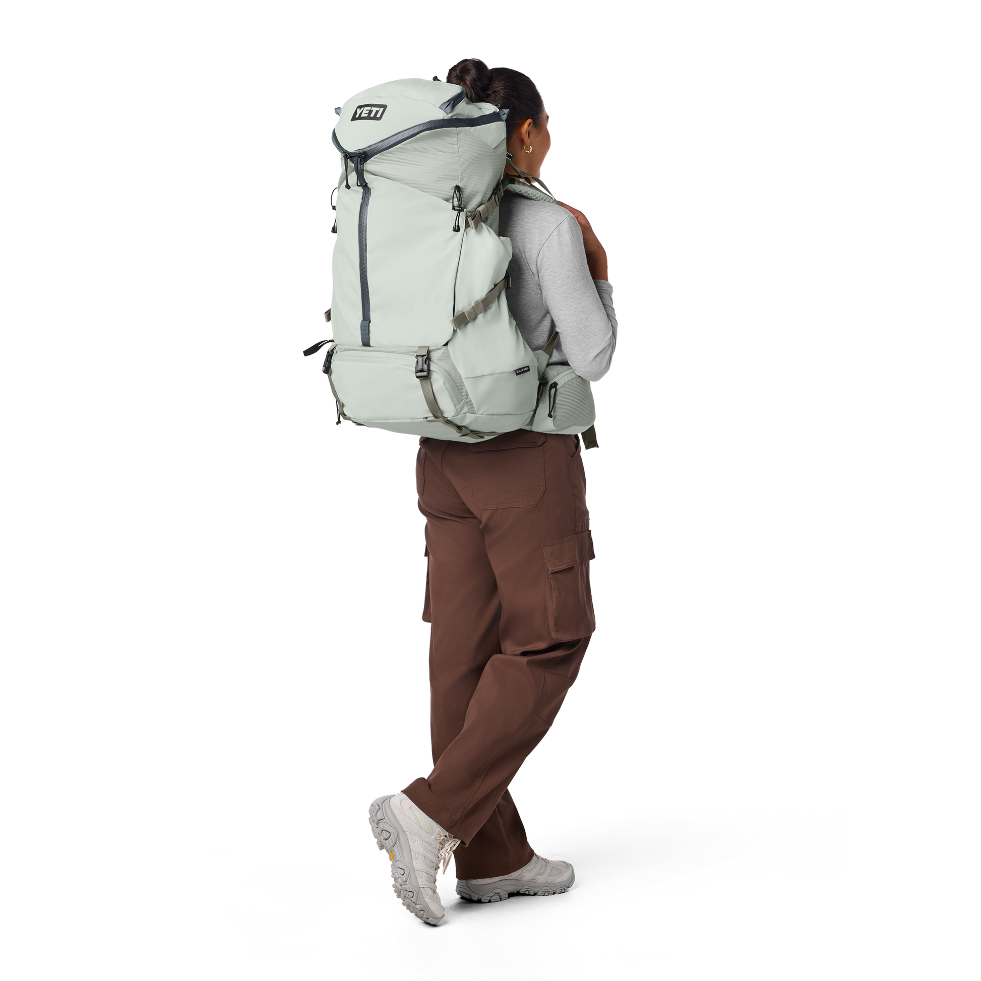 Person wearing a large backpack on a white background