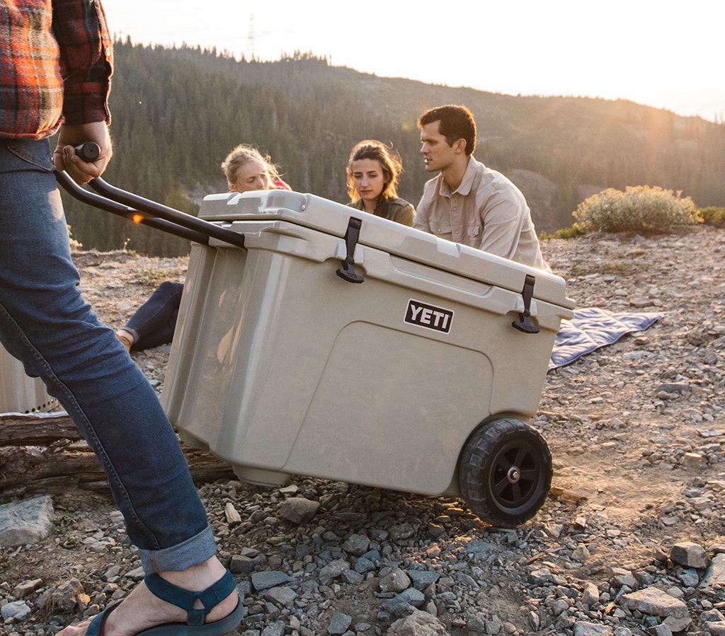 Person wheeling a YETI Wheeled Cool Box