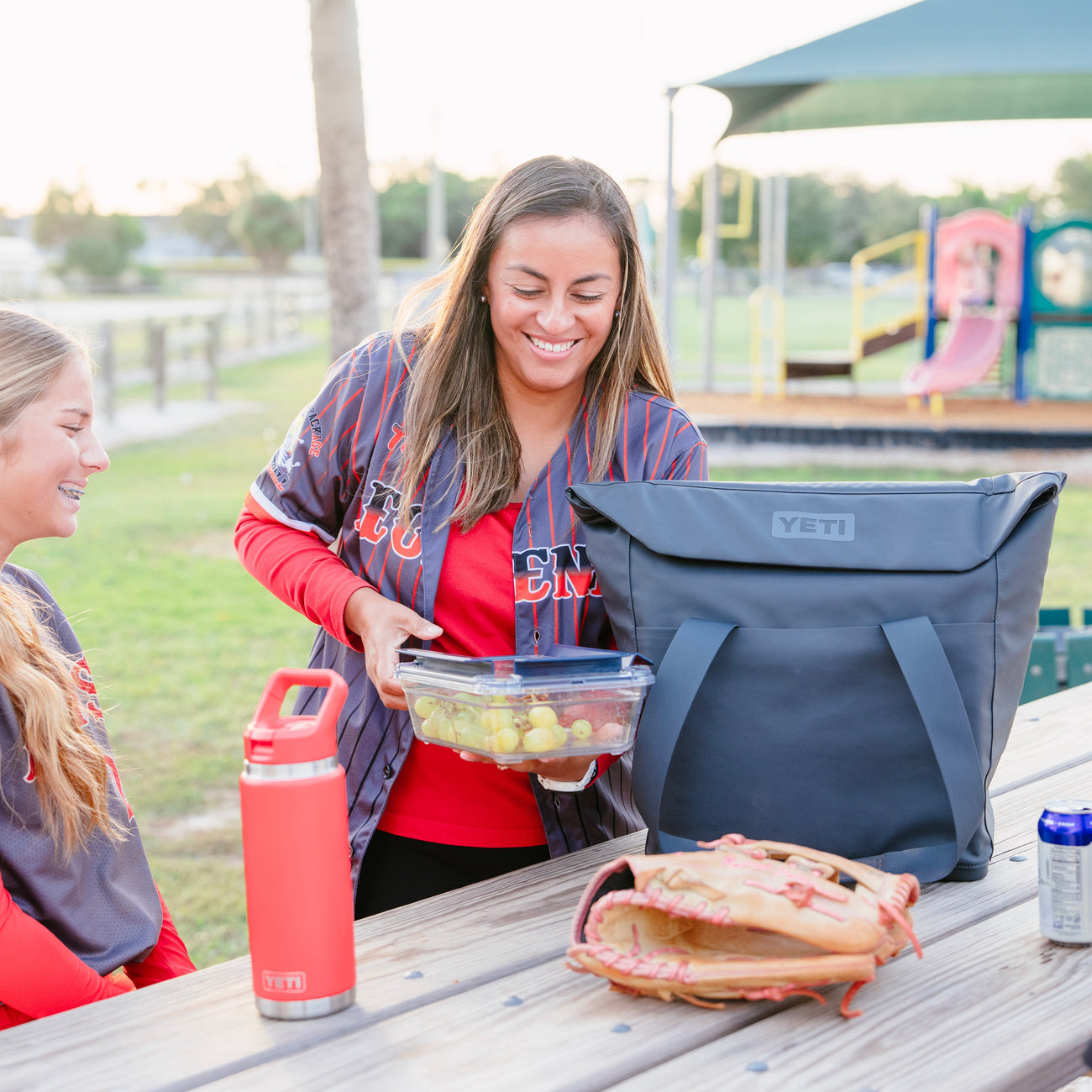 People having a picnic with a YETI tote soft cooler after sports