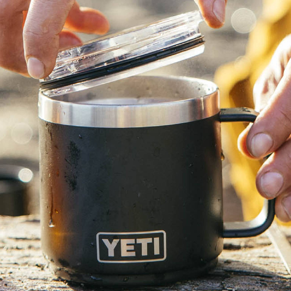 Black YETI mug with a lid on a wooden surface
